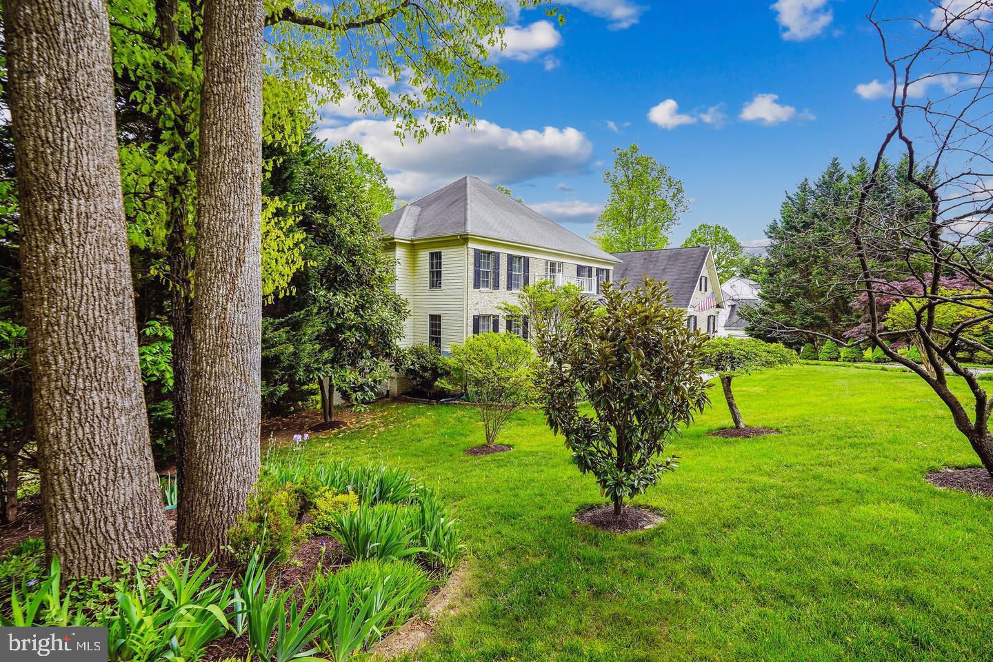 8020 Pohick Road Springfield, VA 22153 - Photo 33 of 57 a view of a house with a yard and potted plants