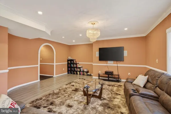 a room with pool table and a chandelier