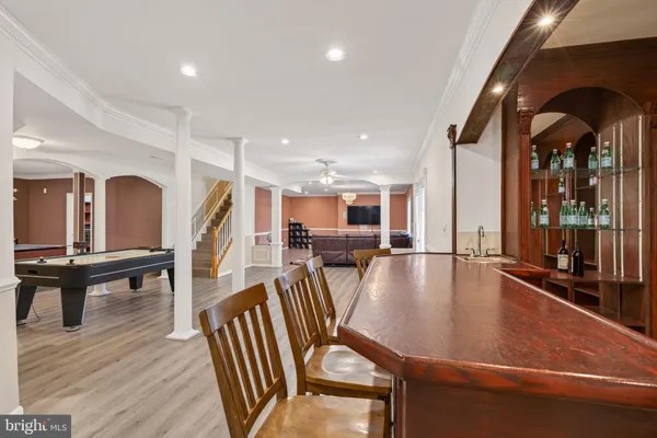 a roof deck with table and chairs and wooden floor