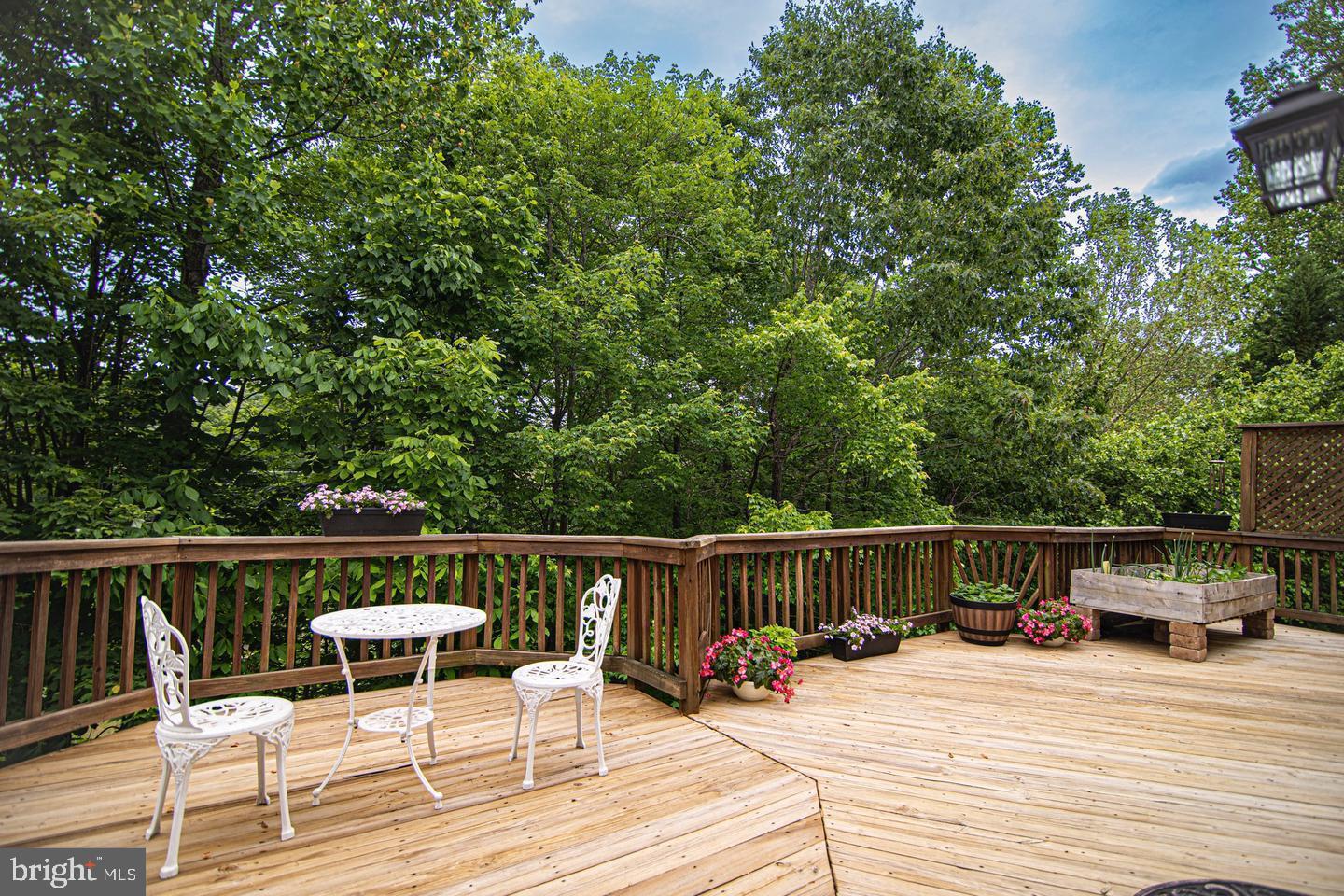 8020 Pohick Road Springfield, VA 22153 - Photo 44 of 57 a roof deck with table and chairs and wooden floor