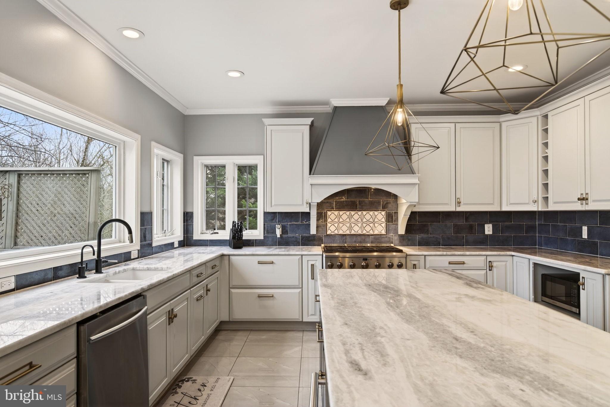 8020 Pohick Road Springfield, VA 22153 - Photo 47 of 57 a kitchen with granite countertop a sink stainless steel appliances and white cabinets