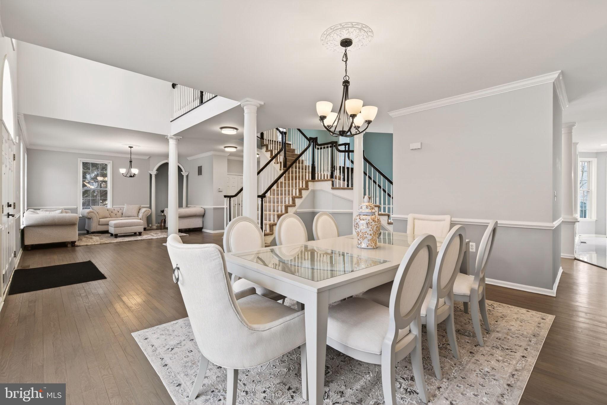 8020 Pohick Road Springfield, VA 22153 - Photo 7 of 57 a view of a dining room and livingroom with furniture wooden floor a chandelier