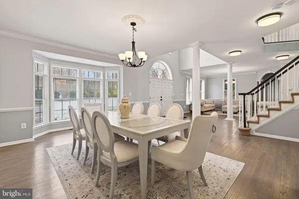 a view of a dining room with furniture wooden floor and chandelier