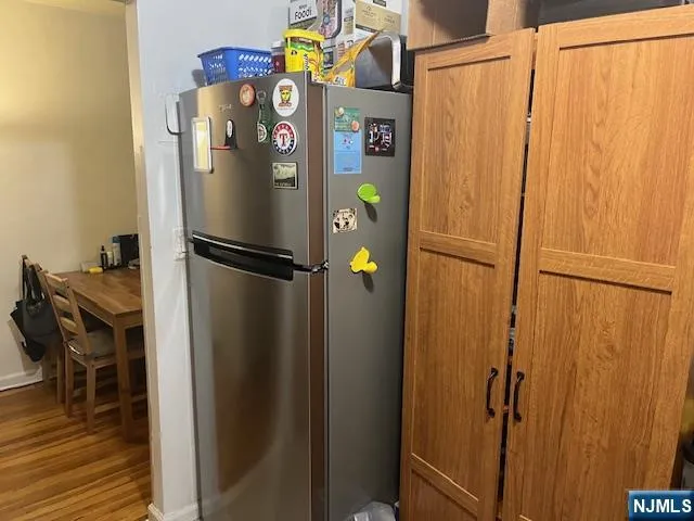 a view of storage and utility room with wooden floor