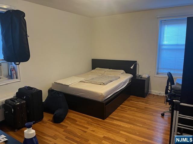 2330 Linwood Avenue, Unit 4F Fort Lee, NJ 07024 - Photo 8 of 13 a bedroom with a bed and a lamp on dresser