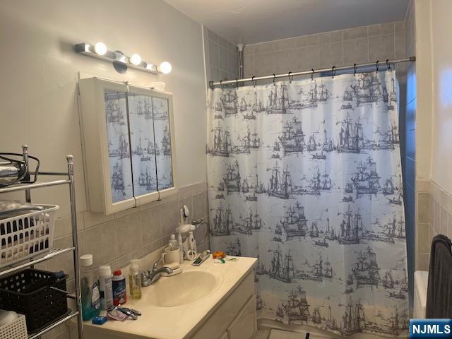 2330 Linwood Avenue, Unit 4F Fort Lee, NJ 07024 - Photo 10 of 13 a bathroom with a sink shower and a mirror