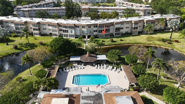 an aerial view of a house with a swimming pool and outdoor seating