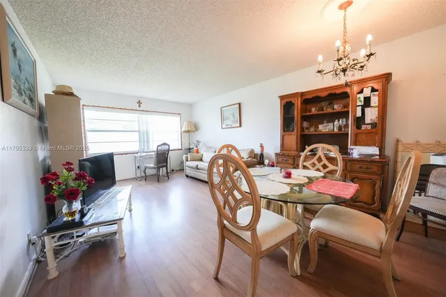 a view of a dining room with furniture wooden floor and chandelier