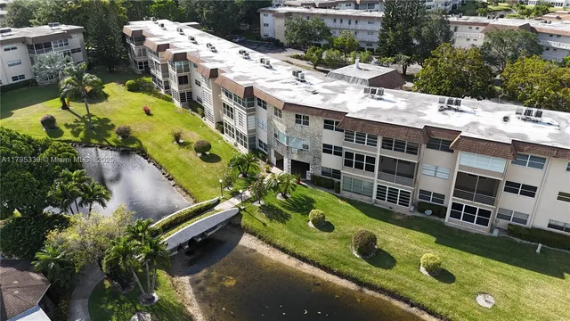 a aerial view of a house with yard swimming pool and outdoor seating