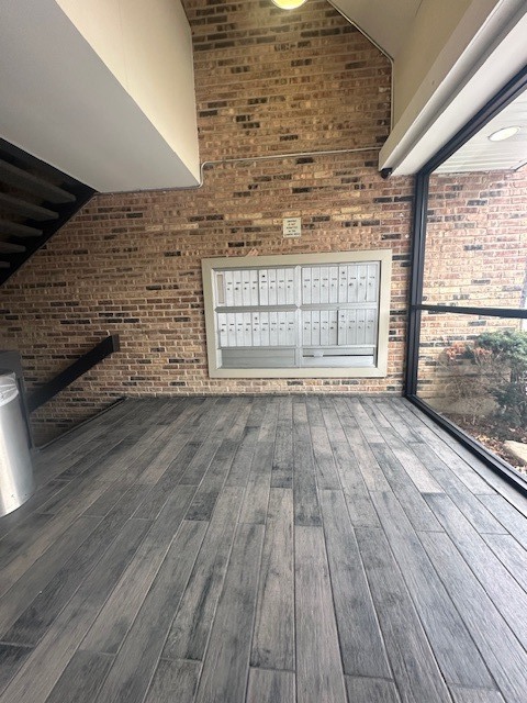 1813 Hemlock Place, Unit 311 Schaumburg, IL 60173 - Photo 5 of 17 a view of empty room with wooden floor and fireplace