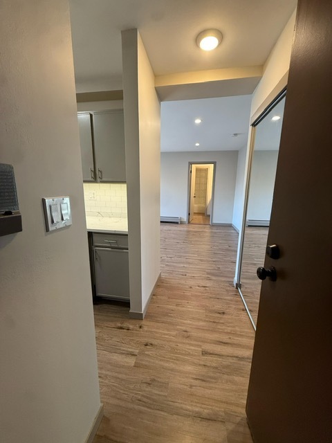 1813 Hemlock Place, Unit 311 Schaumburg, IL 60173 - Photo 6 of 17 a view of a hallway with wooden floor and a bathroom