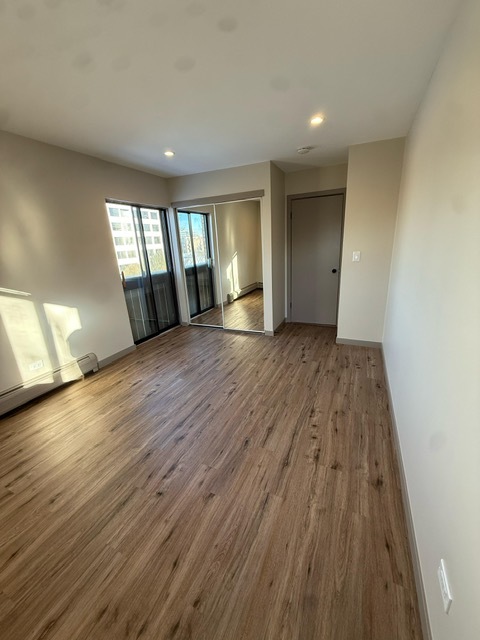 1813 Hemlock Place, Unit 311 Schaumburg, IL 60173 - Photo 10 of 17 wooden floor in an empty room with a window