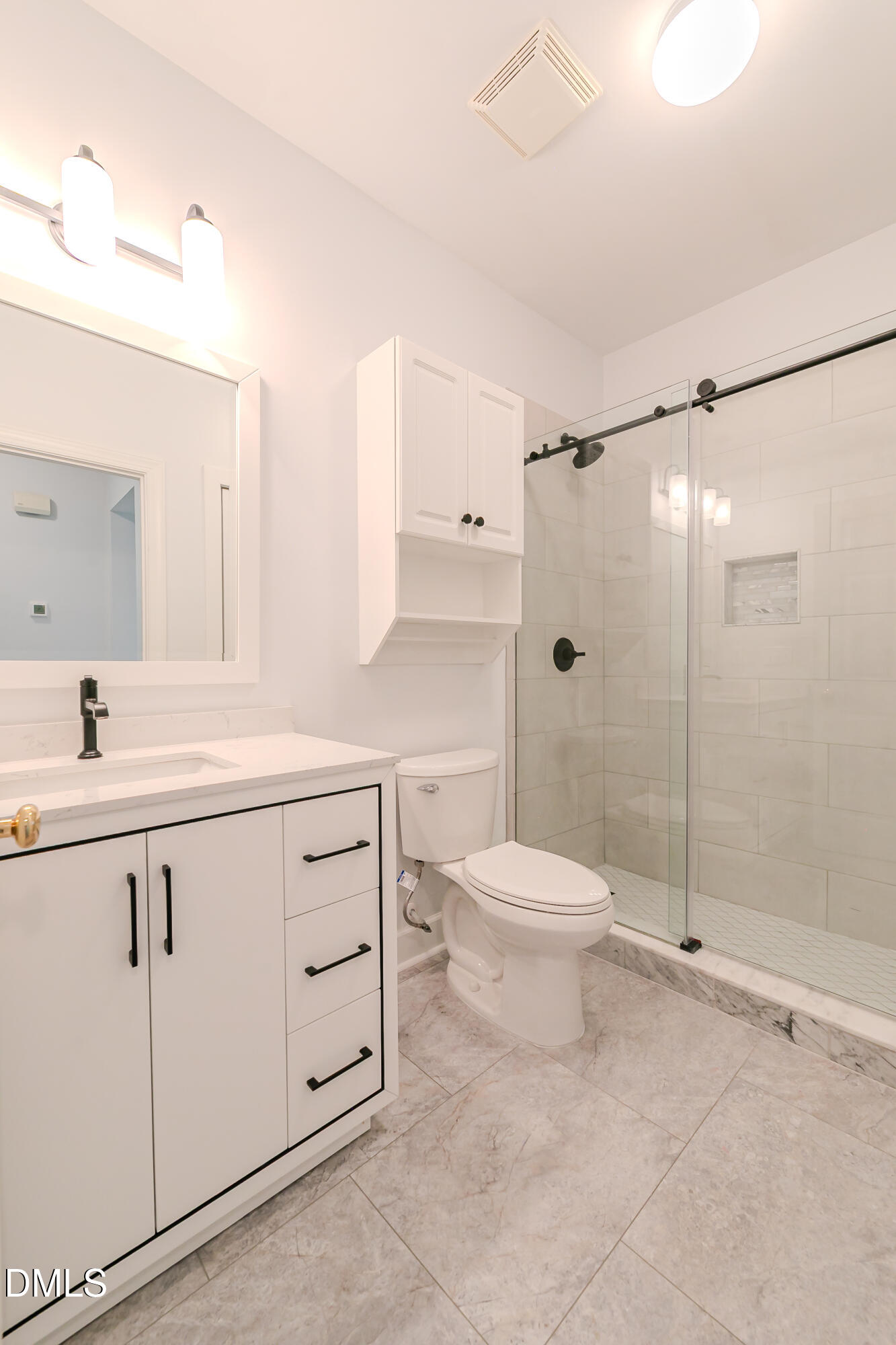 116 Northbrook Drive, Unit 305 Raleigh, NC 27609 - Photo 29 of 43 a bathroom with a shower sink vanity and toilet