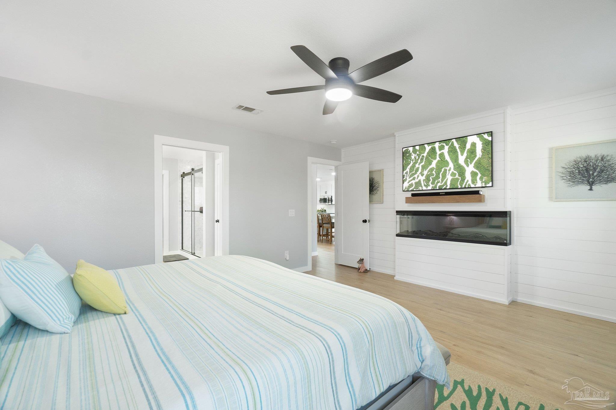 2016 Winners Circle Cantonment, FL 32533 - Photo 13 of 32 a bedroom with a large bed and a chandelier