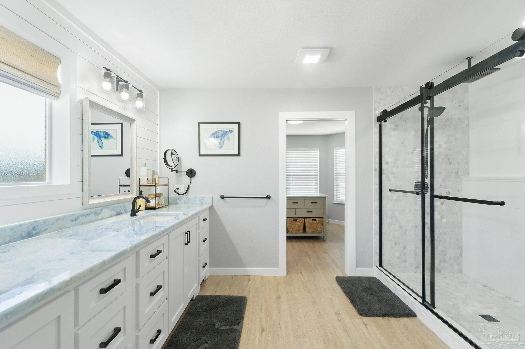 2016 Winners Circle Cantonment, FL 32533 - Photo 15 of 32 a spacious bathroom with a granite countertop sink mirror and shower