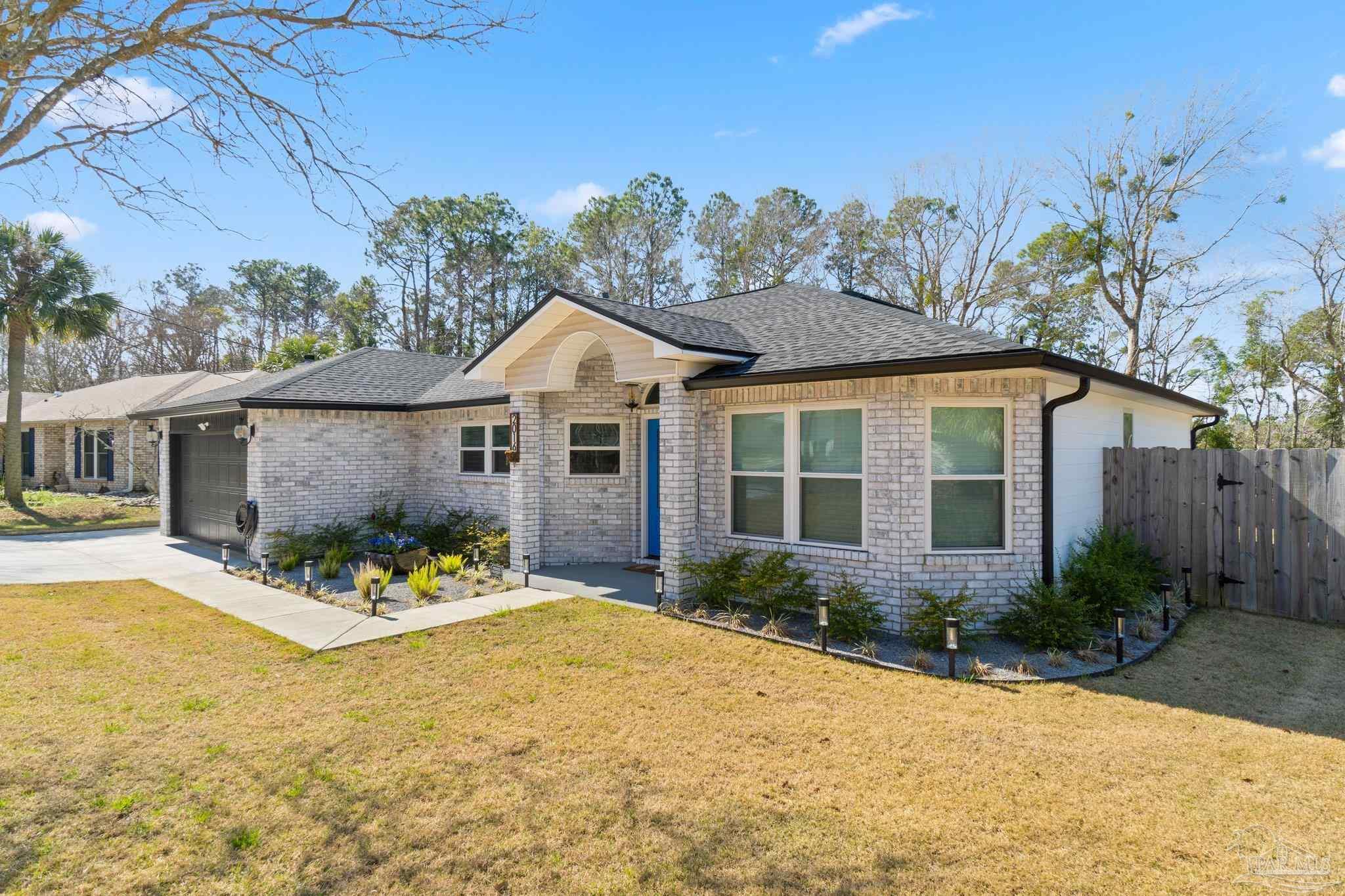 2016 Winners Circle Cantonment, FL 32533 - Photo 2 of 32 a front view of a house with a yard
