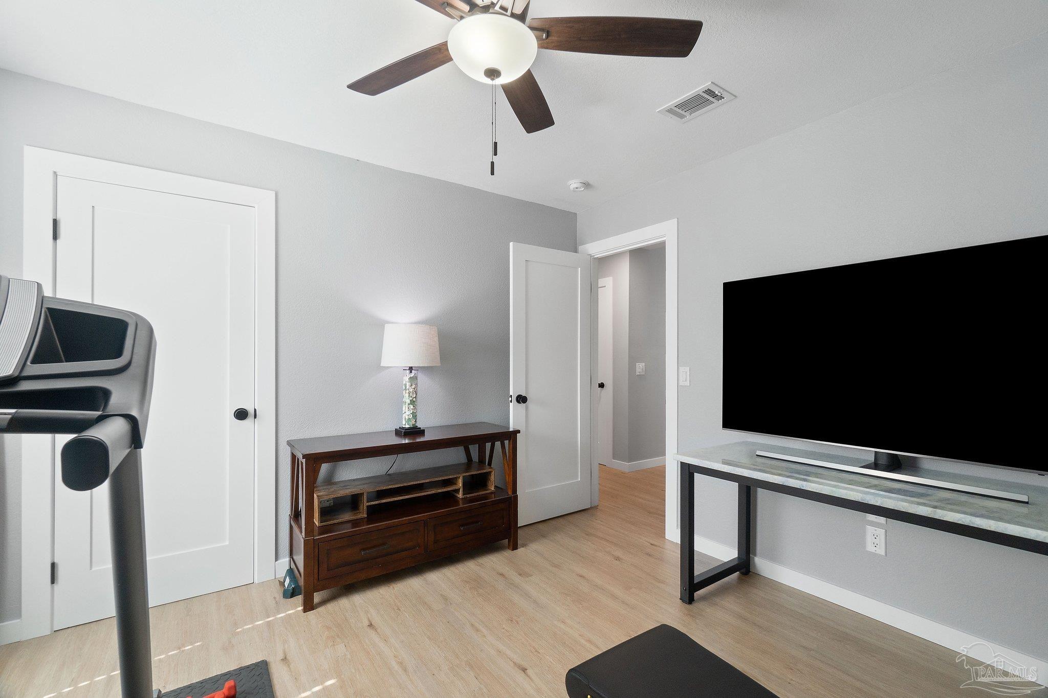 2016 Winners Circle Cantonment, FL 32533 - Photo 23 of 32 a living room with furniture and a flat screen tv