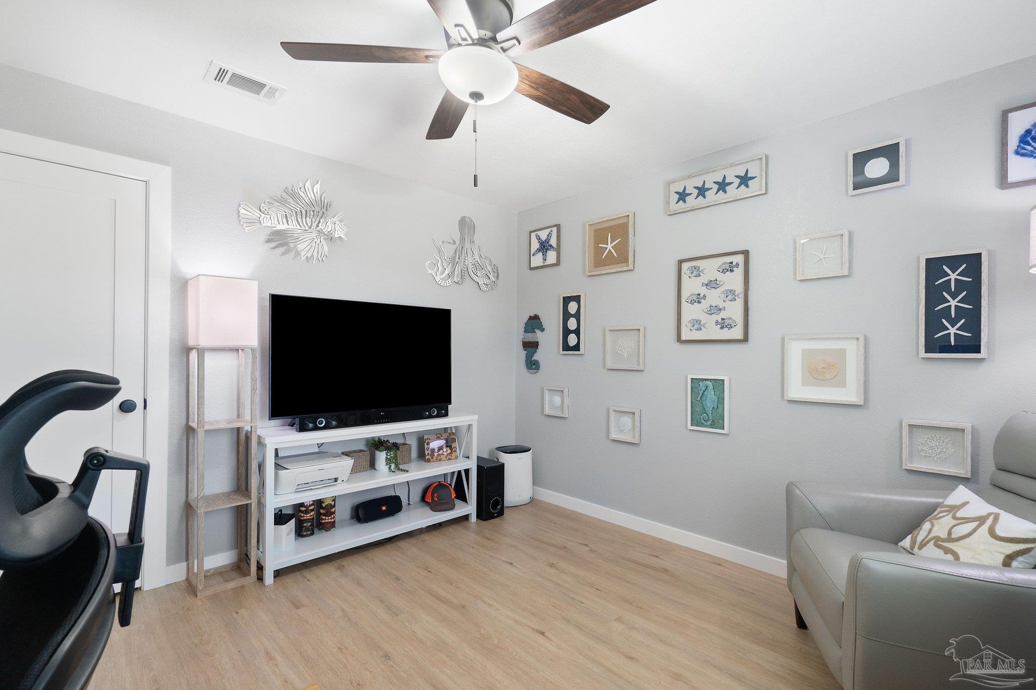 2016 Winners Circle Cantonment, FL 32533 - Photo 25 of 32 a living room with furniture and a flat screen tv