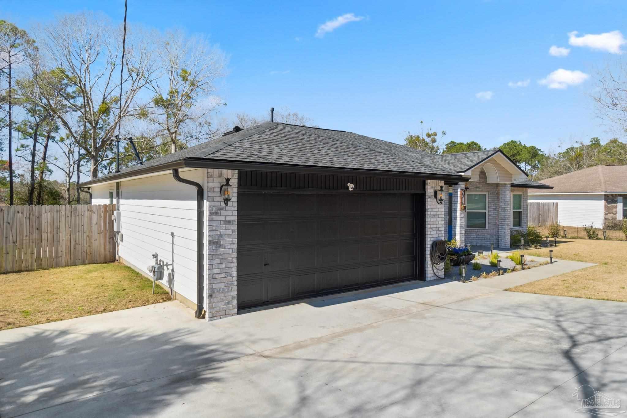 2016 Winners Circle Cantonment, FL 32533 - Photo 3 of 32 a front view of a house with a yard
