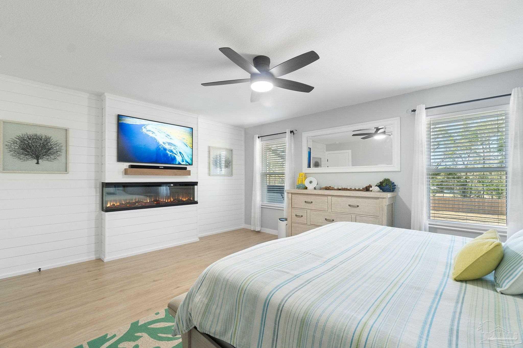 2016 Winners Circle Cantonment, FL 32533 - Photo 10 of 32 a bedroom with a bed and a flat screen tv