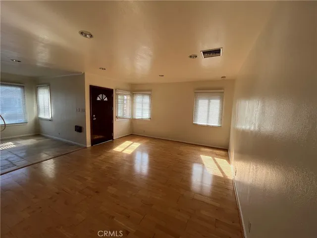 an empty room with windows and entrance