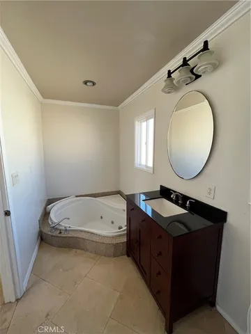 a bathroom with a tub sink and mirror