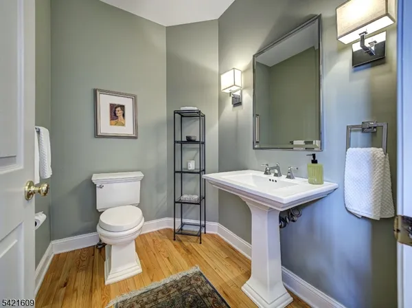 a bathroom with a sink toilet and mirror