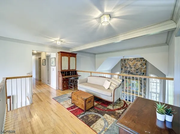 a living room with furniture fireplace and wooden floor
