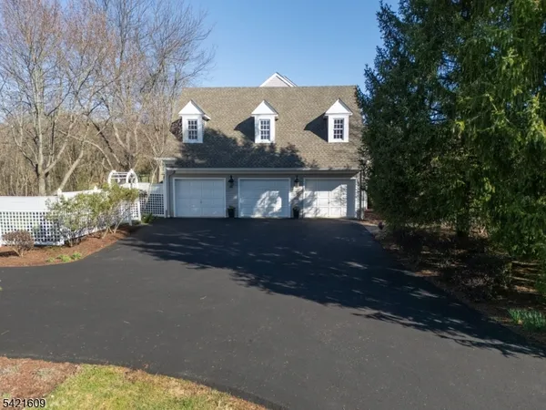a front view of a house with a yard and parking