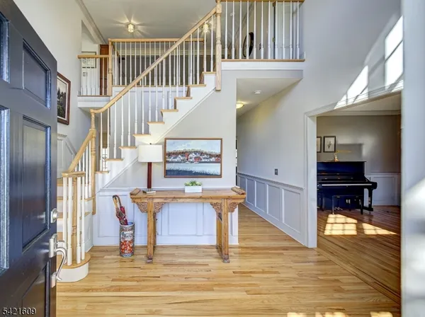 a view of entryway livingroom and hall with wooden floor