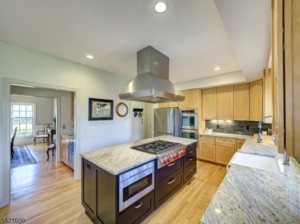 a kitchen with stainless steel appliances granite countertop a stove oven and a refrigerator