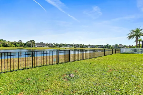 a kitchen with kitchen island a sink and a large window
