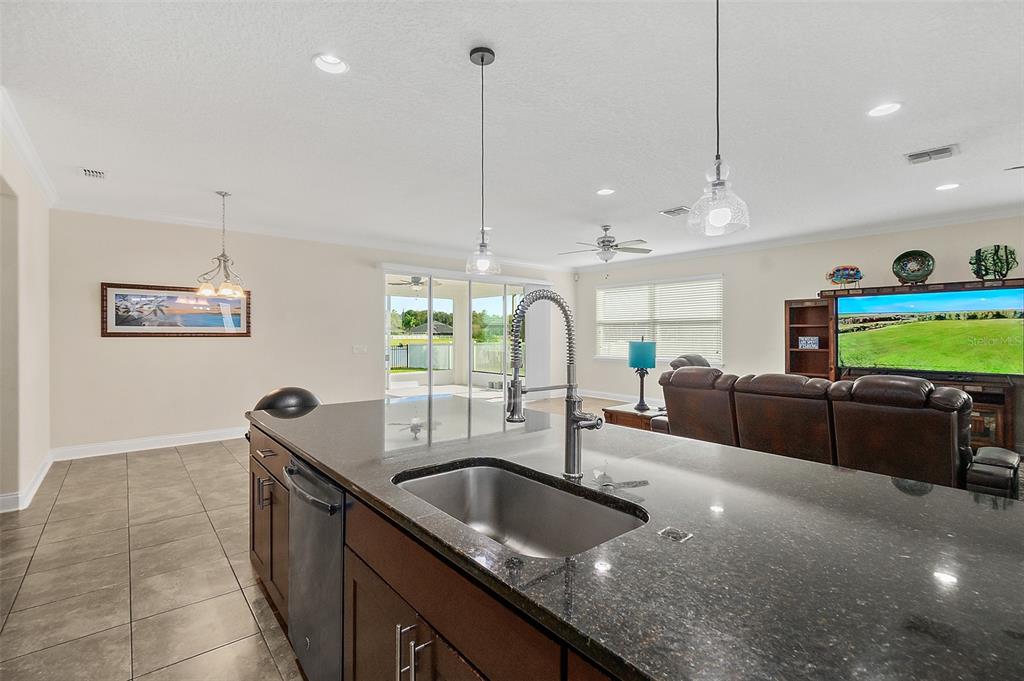 39 Turtle Ridge Drive Flagler Beach, FL 32136 - Photo 22 of 58 a kitchen with kitchen island a sink and a large window