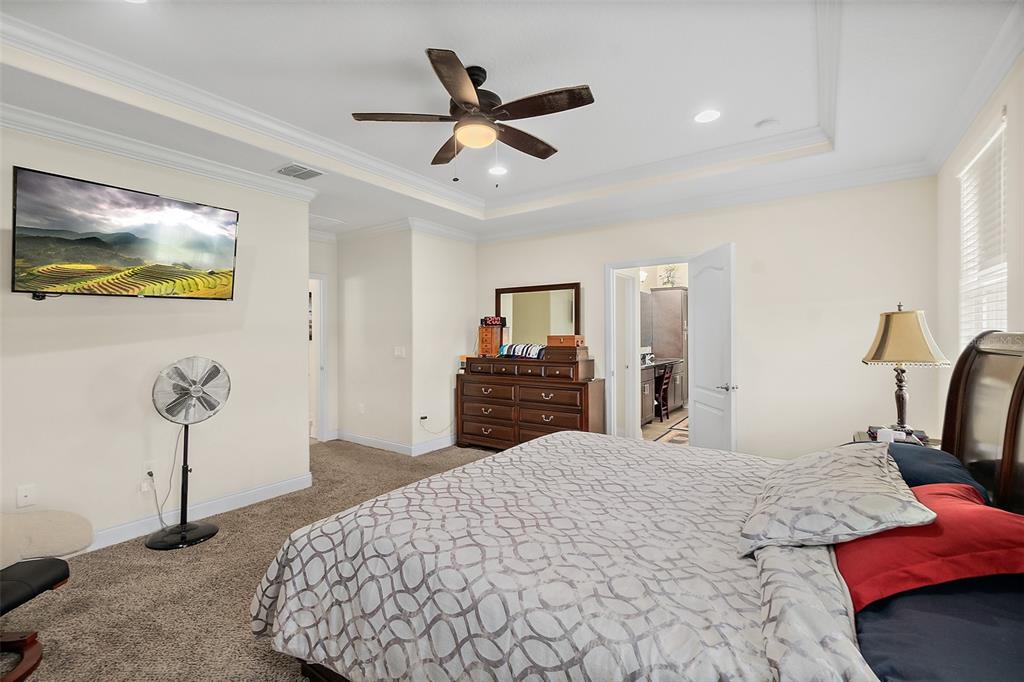 39 Turtle Ridge Drive Flagler Beach, FL 32136 - Photo 24 of 58 a bedroom with a bed and a ceiling fan