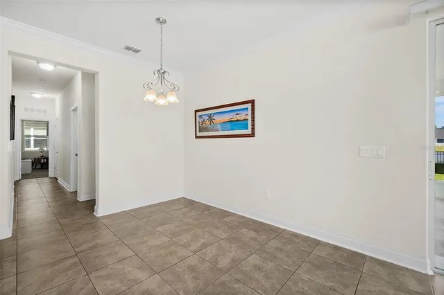 a bedroom with a bed and painting on the wall