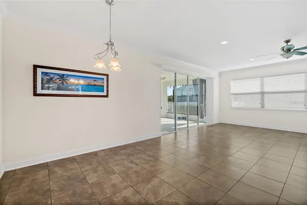 a living room with couches and kitchen view with wooden floor
