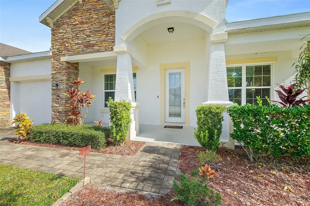 an aerial view of residential houses with outdoor space and lake view