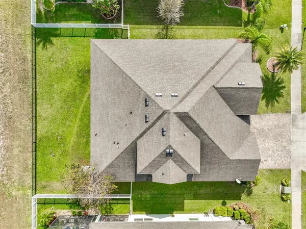 an aerial view of residential houses with outdoor space and river