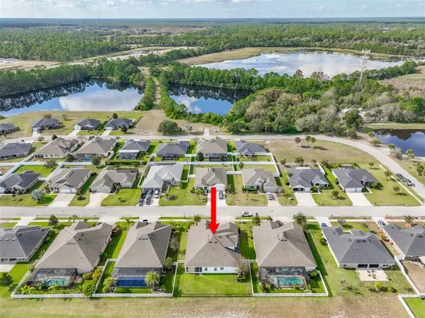 an aerial view of residential houses with outdoor space and river