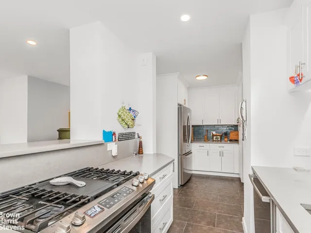 a kitchen with a stove and a refrigerator