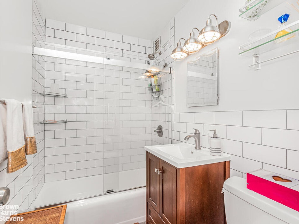 3777 Independence Avenue, Unit 4D Bronx, NY 10463 - Photo 19 of 29 a bathroom with a sink and a mirror