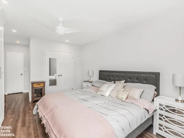 a bedroom with a large bed and a chandelier