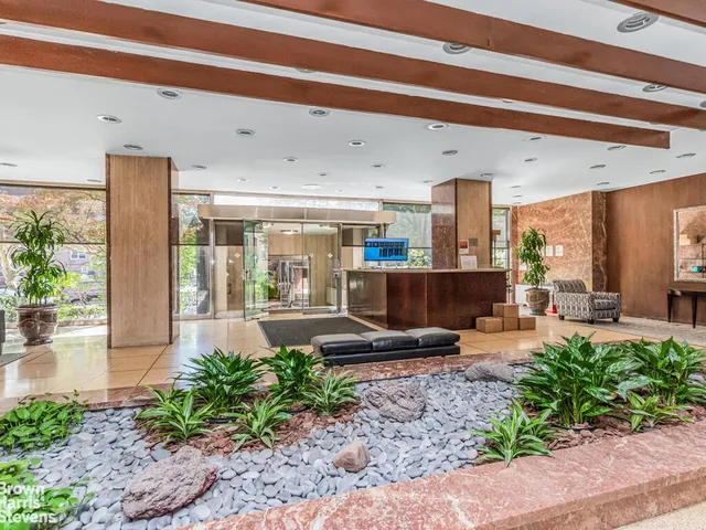 a lobby with furniture and a potted plant