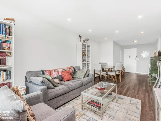 a living room with furniture and a book shelf