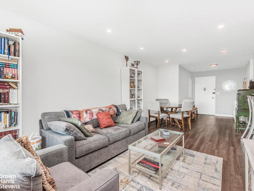 3777 Independence Avenue, Unit 4D Bronx, NY 10463 - Photo 2 of 29 a living room with furniture and a book shelf