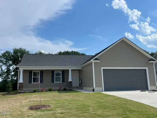 a view of a yard in front of a house with garage