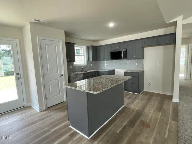 a view of kitchen with sink and wooden floor