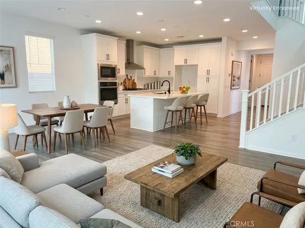 a living room with furniture kitchen view and a dining table