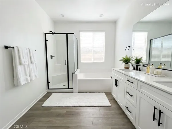a bathroom with a tub sink and mirror