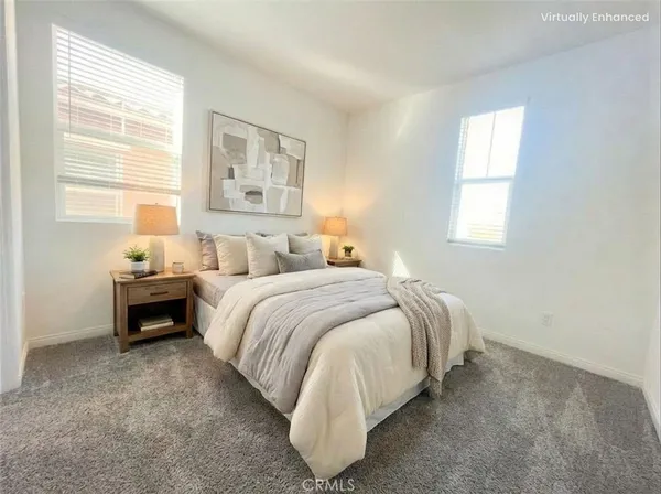 a spacious bedroom with a bed and window